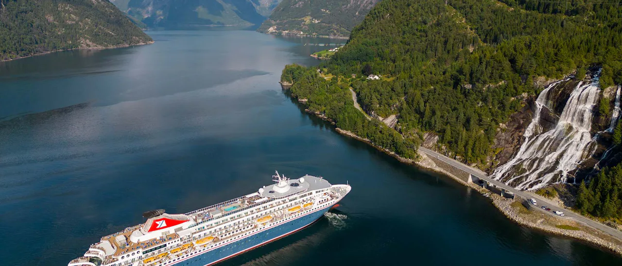Fred Olsen Balmoral at waterfall in Norwegian Fjords