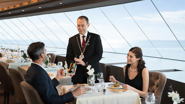 A couple has dinner in the MSC Yacht Club private restaurant