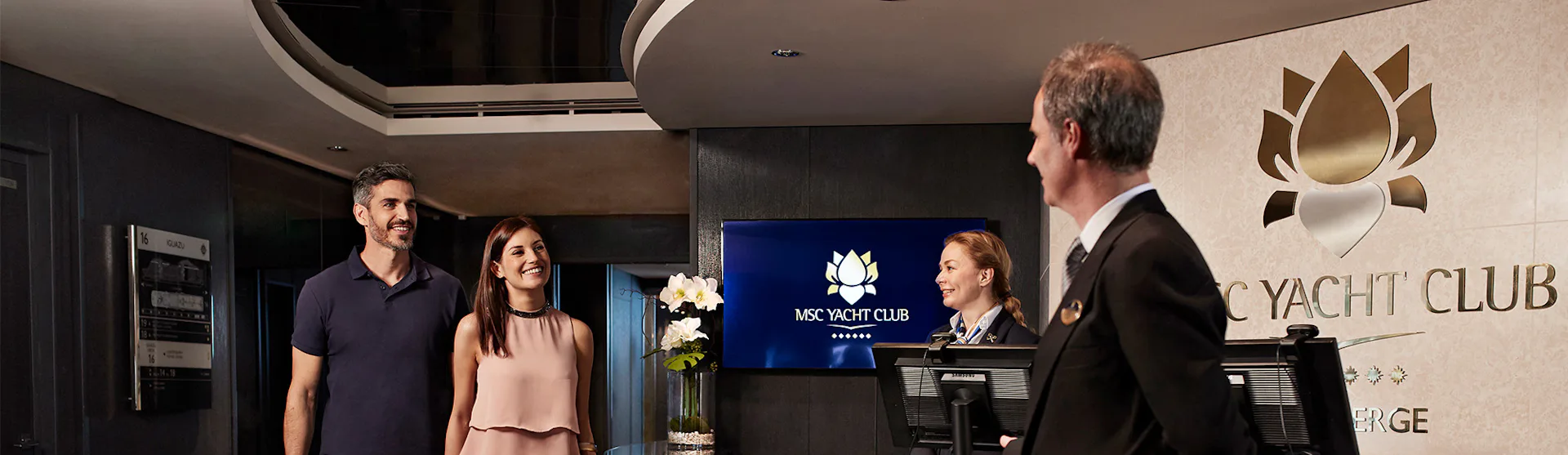 A butler welcomes guests to MSC Yacht Club
