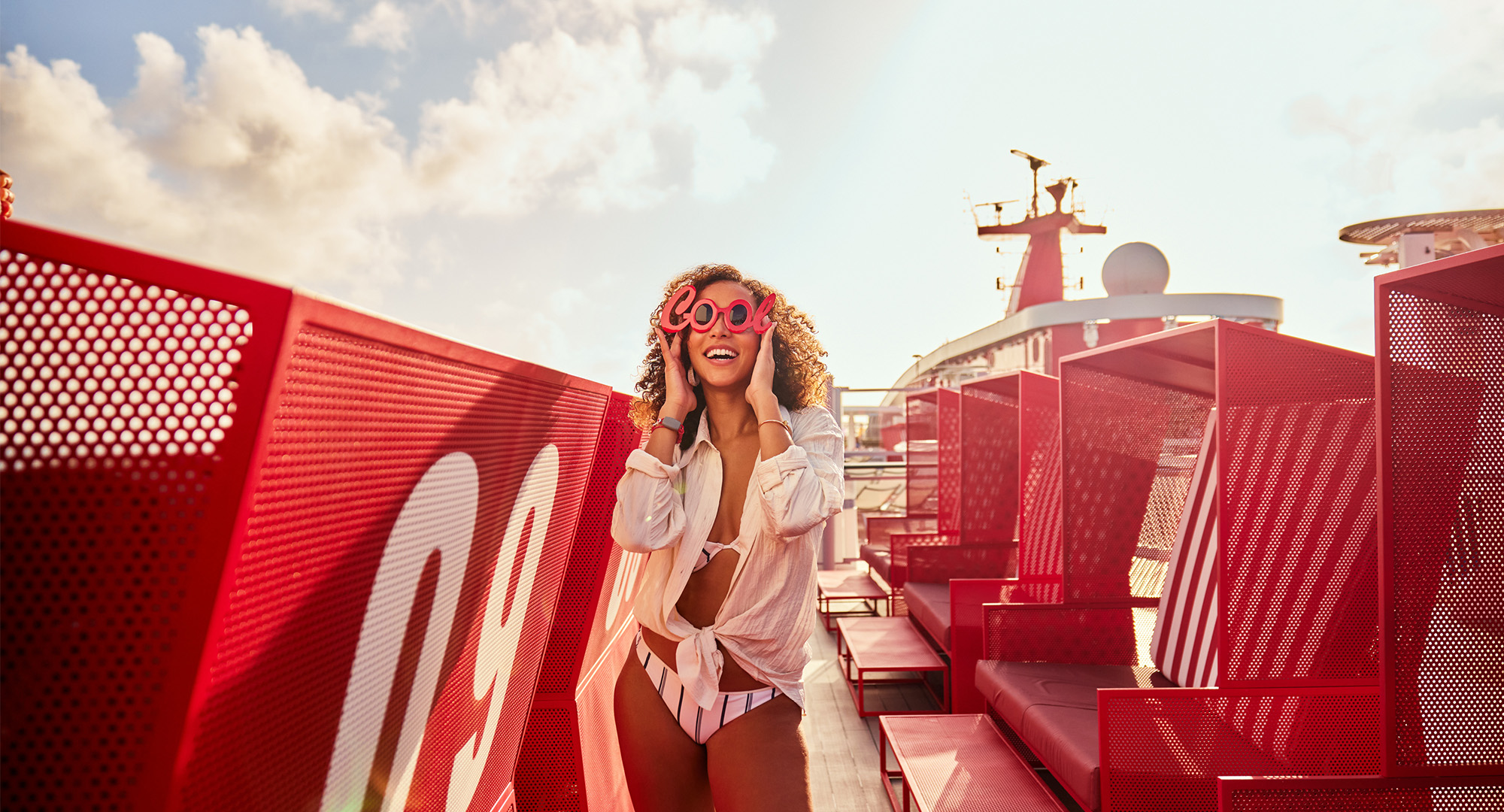 Woman chilling on top deck on one of Virgin Voyages' ladyships