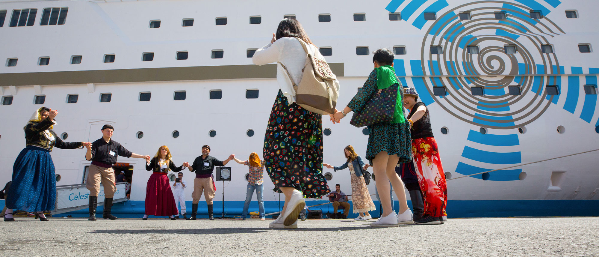 Greek dancers welcoming guests onboard