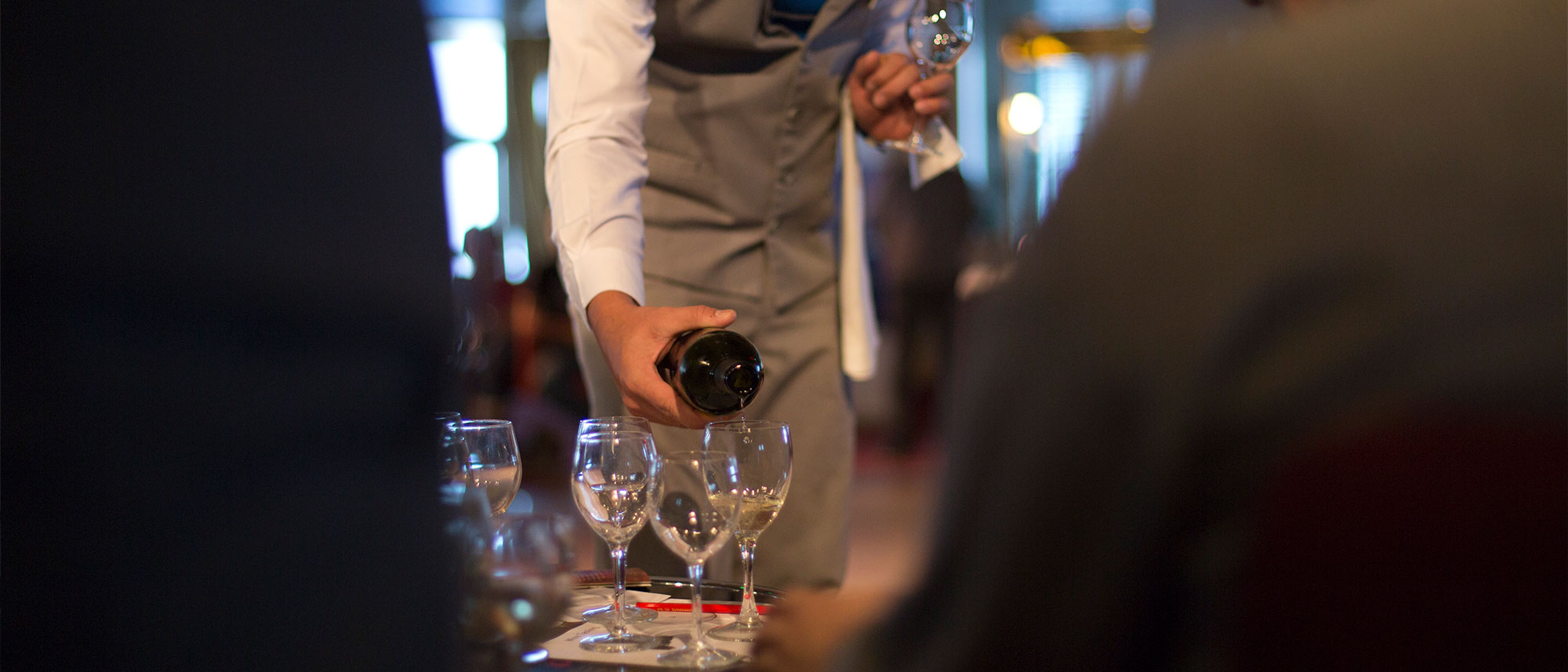 Waiter serving wine