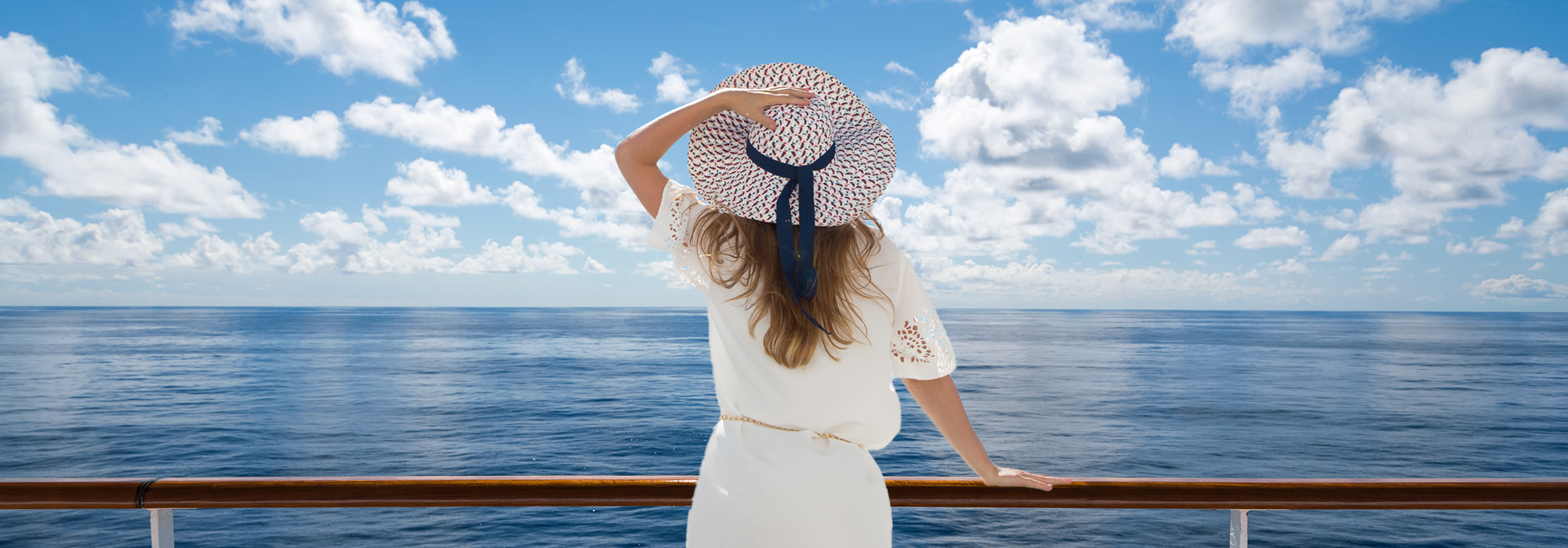 Woman looking out to sea from balcony