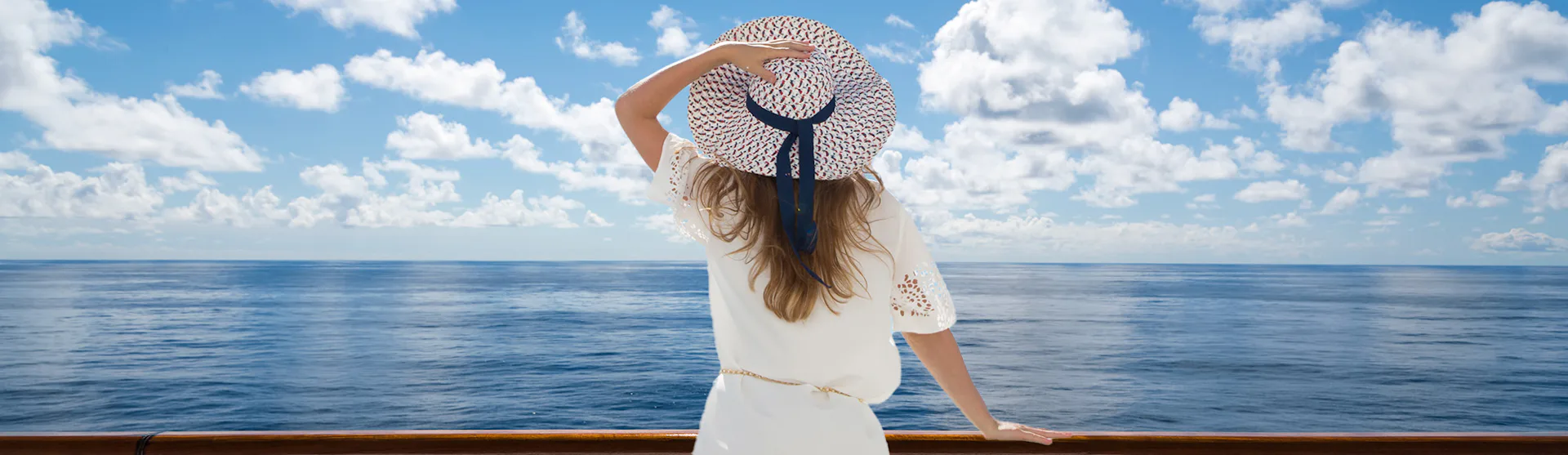 Woman looking out to sea from balcony