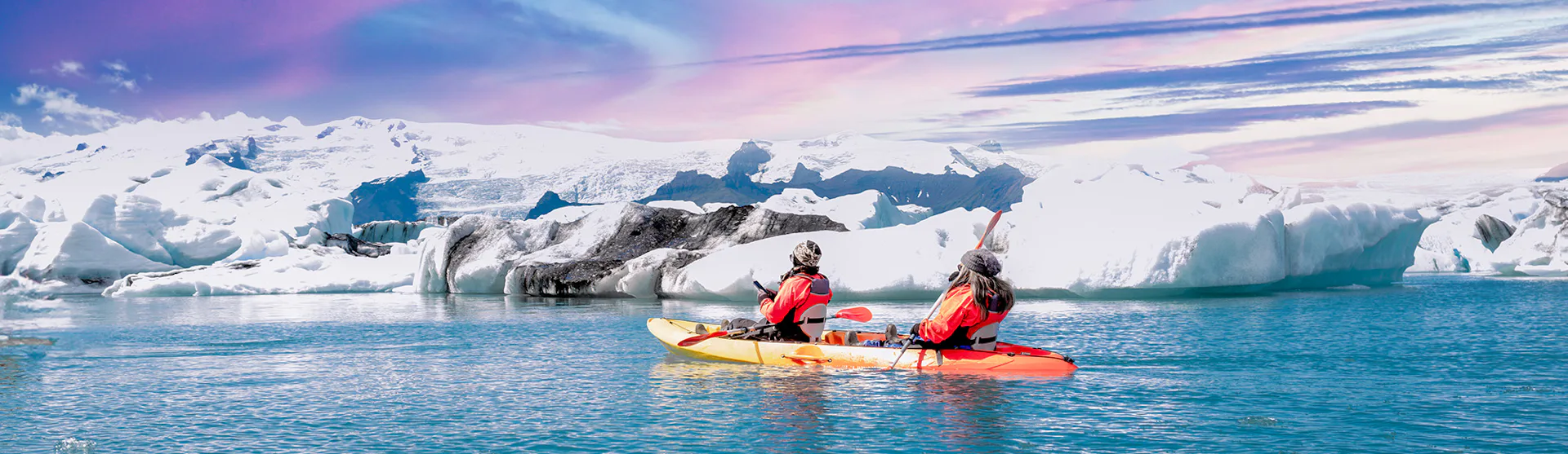 Kayaking beside an ice sheets near Iceland