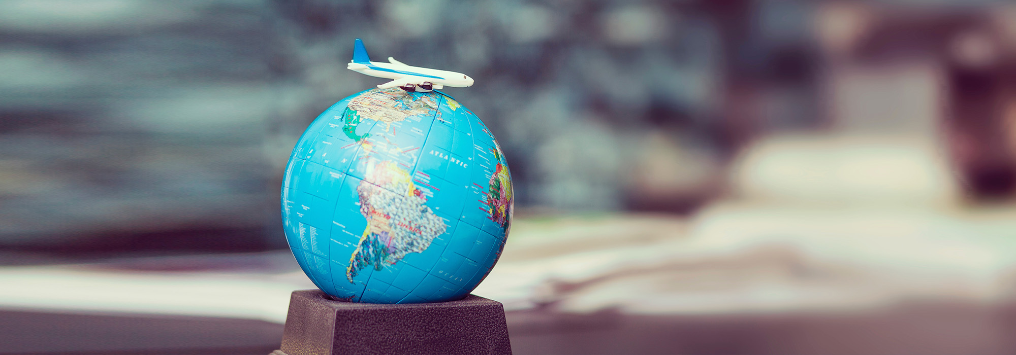 Plane atop a toy world globe
