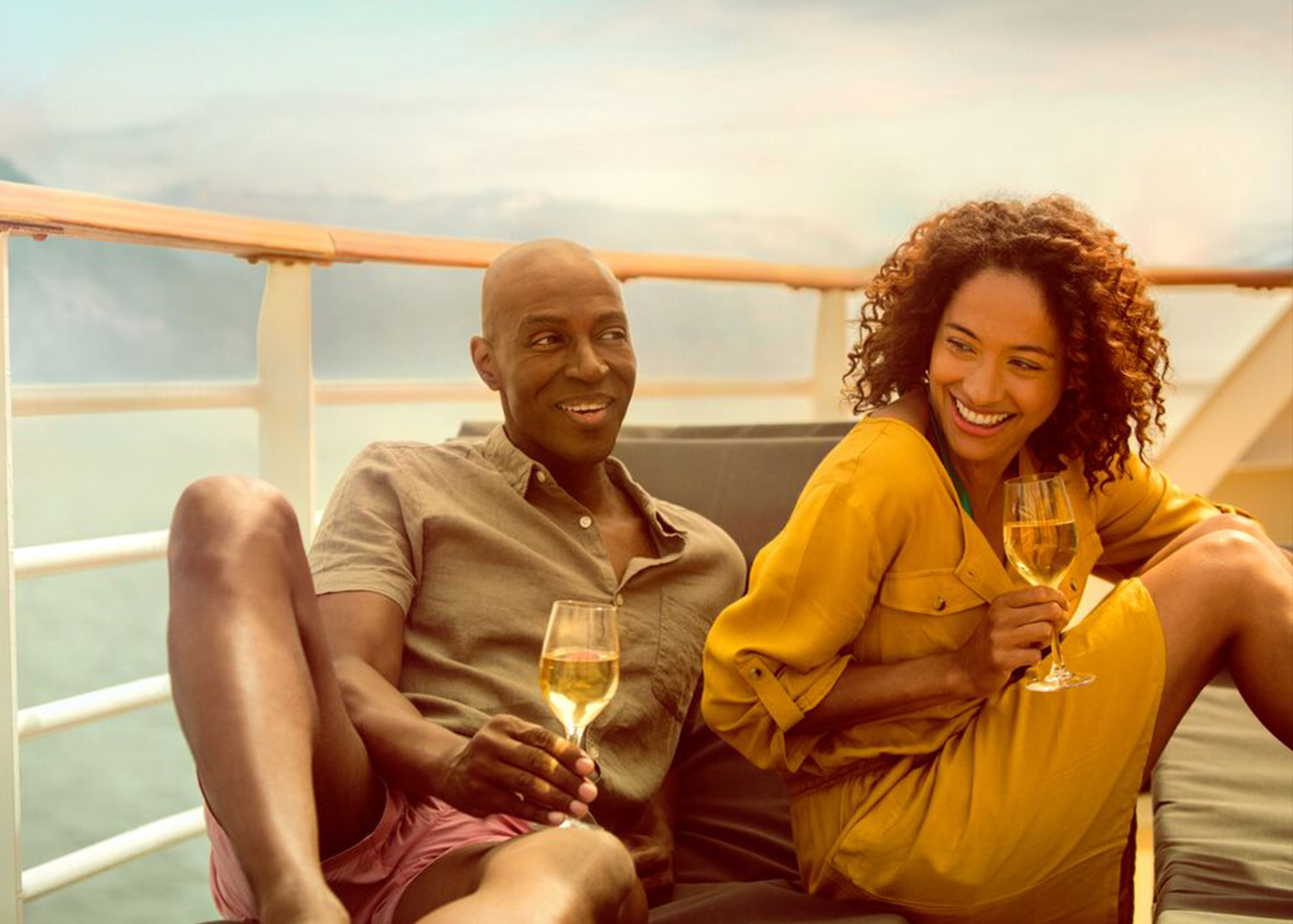 Couple enjoying drinks on deck