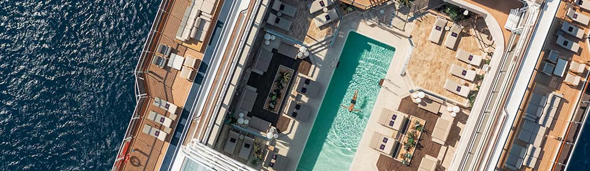 Man floating in the sunshine in EXPLORA pool