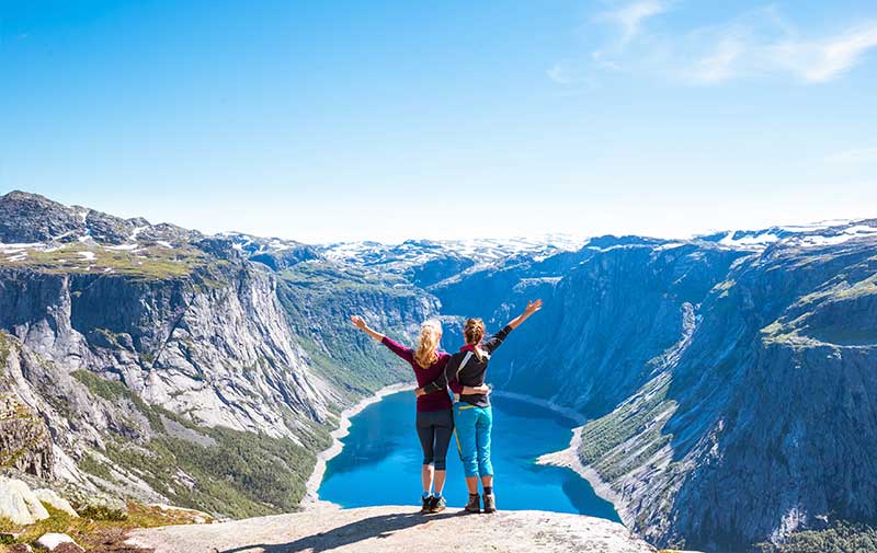Friends overlooking Trolltunga Norwegian Fjords